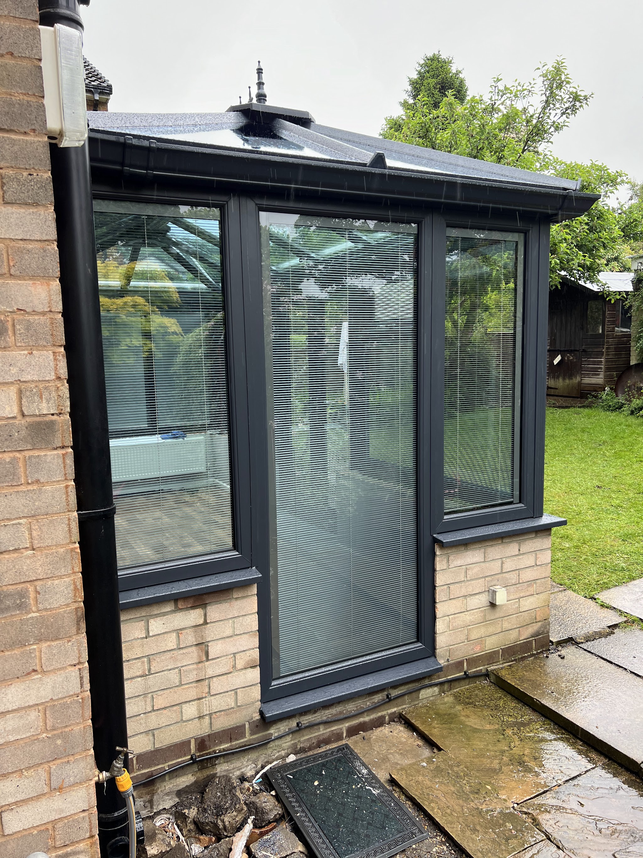 Charcoal window frames and door on a garden conservatory