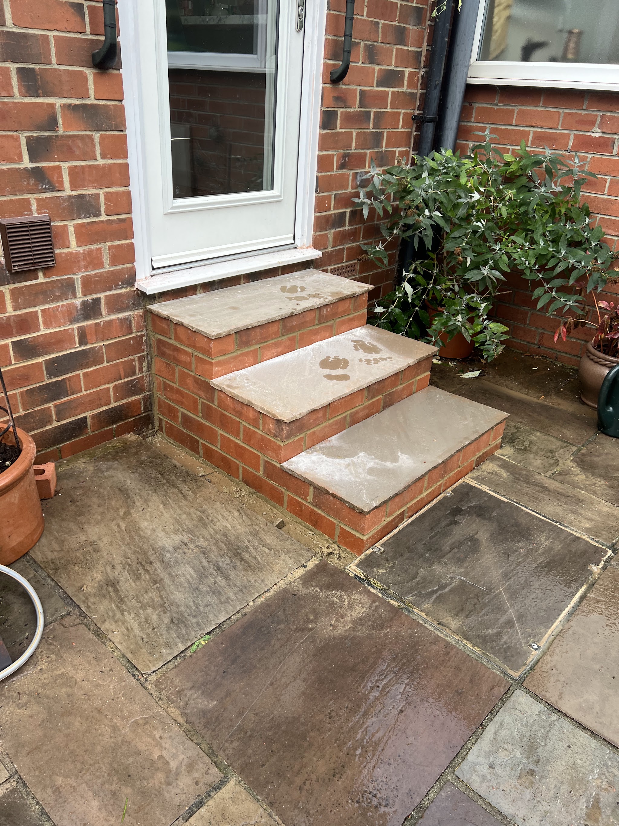 Stone-topped brick steps leading to a back door