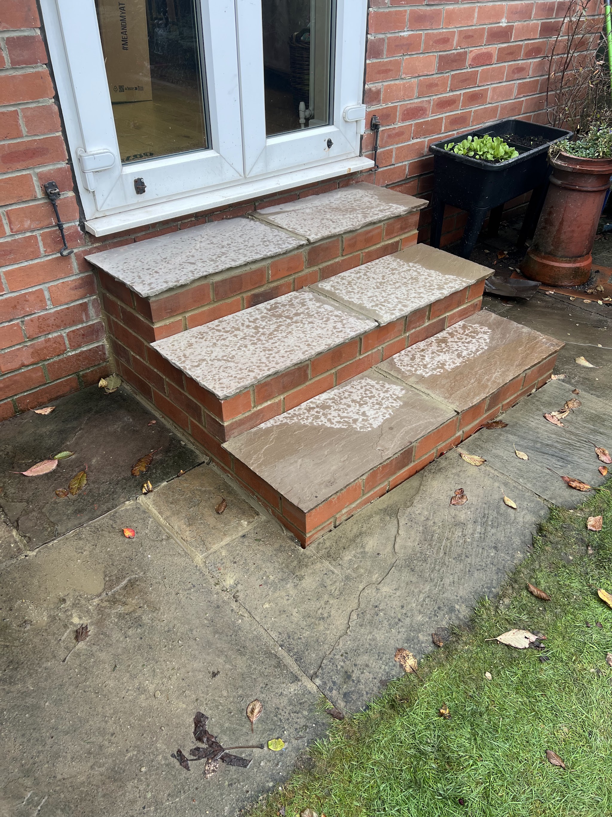 A second set of broad brick steps with stone treads